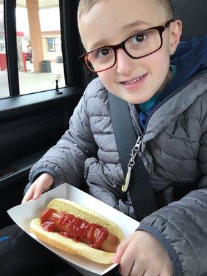 Happy kid with a $.99 jumbo dog.