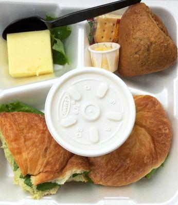 Delite Plate with an avocado chicken salad sandwich, a sweet roll with honey butter, soup, and a slice of jello (pictured top left).