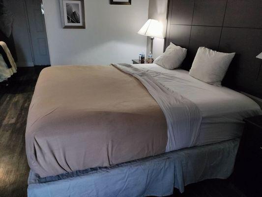 The bed is made with the sheet and blanket almost  halfway down the bed and there were just these dinky pillows.