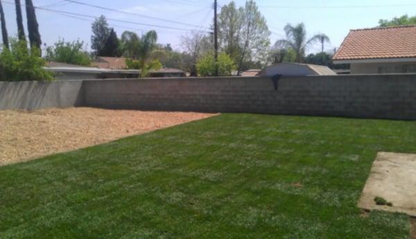 New Sod installation with wood chip flowerbeds