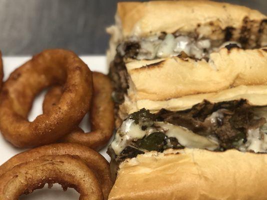 Philly steak sandwich with onion rings