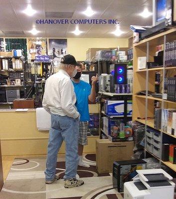 Customer discussing laptop with John Chin of Hanovercomputersva.com