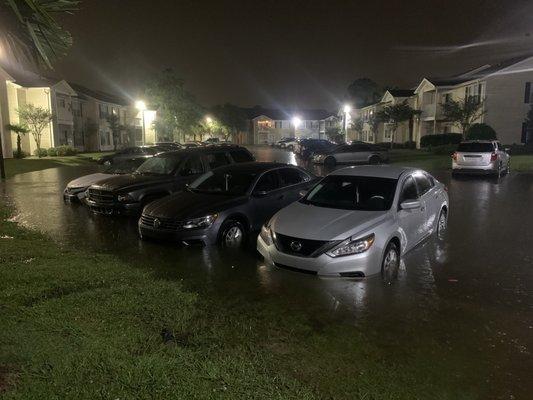 This is a parking lot located next to the leasing office, water was about 2 ft deep and into cars on May 23th 2022 at 11:50 pm