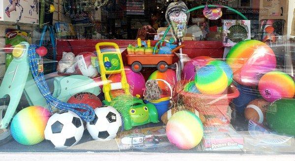 Window display with colorful balls and hula hoops