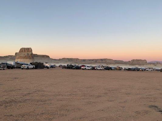 cars and RVs set up to camp at sunset