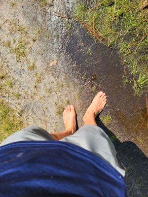 Barefoot in the mud.