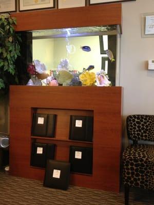 Books under fish tank have cosmetic procedures before & after photos.