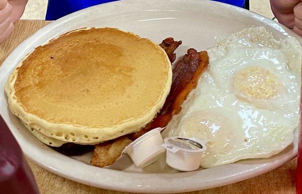 Breakfast platter with eggs over medium and bacon