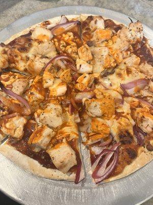 BBQ pizza with buffalo sauce drizzled on top