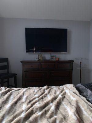 65" TV mounted in my master bedroom. Didn't opt to hid wires as they are barely visible.