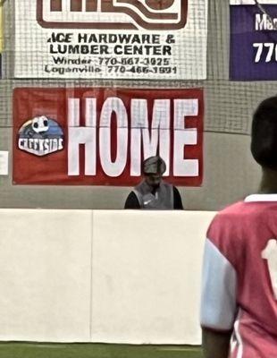 Coach spent much of the game looking down, either on phone or playing with a soccer ball.