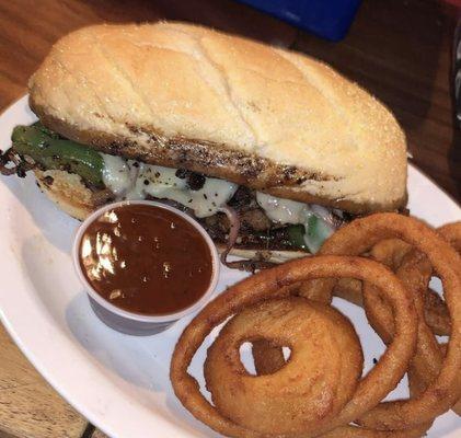 Classic Philly cheesesteak with sautéed peppers and onions provolone cheese, don't forget about upgrading to onion rings!