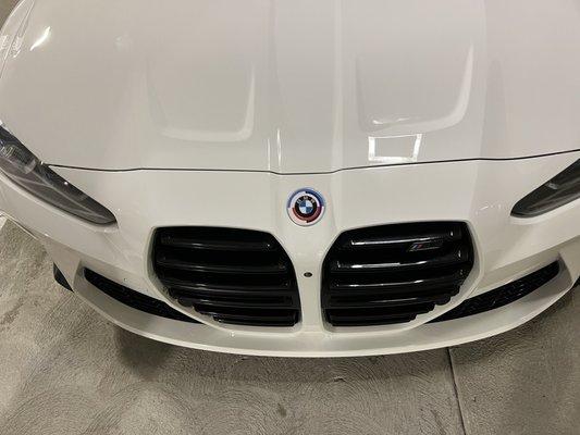 You can see where the bumper and hood meet there is a white spray line going horizontally left to right across the hood.