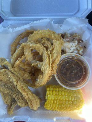 Grilled shrimp, fried catfish, corn on the cob, baked beans, and onion rings