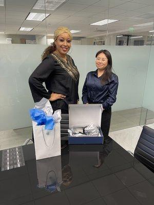 One of our happy clients picking up her settlement check and a gift.