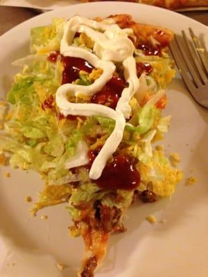 Taco pizza slathered in taco sauce and sour cream....YUUUUUMMM