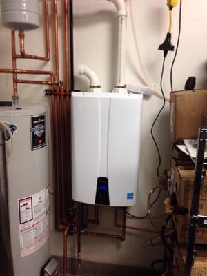 Tankless water heater hooked into other hot water distribution to ramp up efficiency