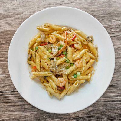 Seafood Pasta Jambalya- Shrimp and Italian sausage with mushrooms, green onions and red peppers. Finished with Cajun garlic cream sauce.