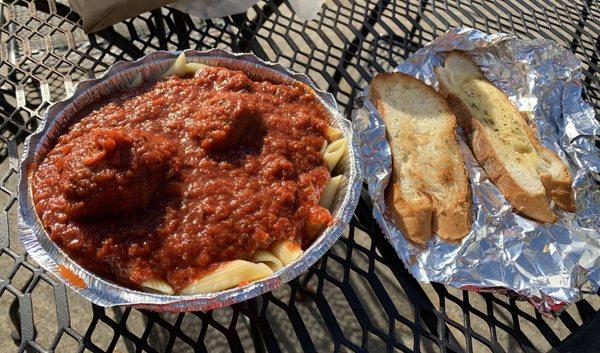 Penne with meatballs and garlic bread.