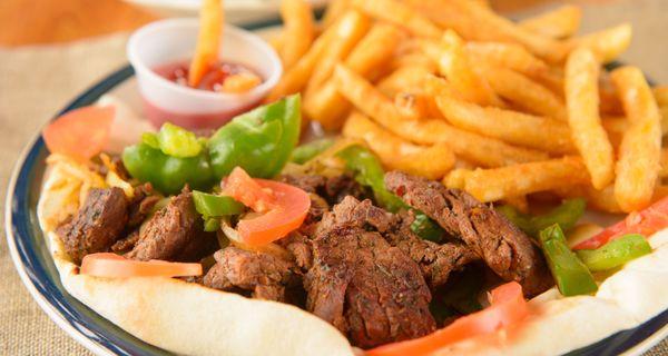 Steak Tip Dinner With Cooked Onions And Green Peppers