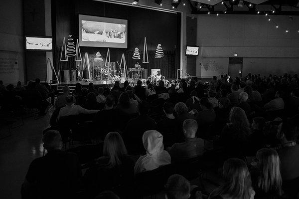 Crowd with message being given from stage