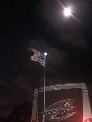 Full moon just showing off my old glory flying high on my new flag pole with a solar light!