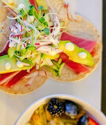 Ahi Tacos with seared ahi tuna, corn tortillas, lemon aioli, radish, cucumber, and microgreens