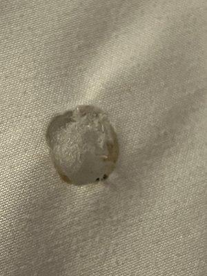 Cigarette burn in comforter.