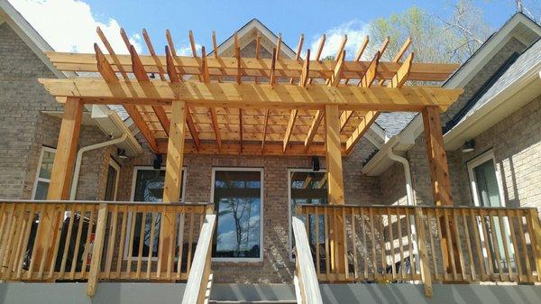 Large-scale pergola over back deck.