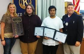 Kiwanis Club President Tyler Smail posing with some students of the quarter.