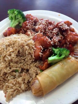 Sesame chicken and fried rice with a vegetable egg roll