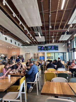 Inside area, very clean and modern, great music + TVs to watch BNP Paribas Open. Tables, bar seating and outdoor seating.