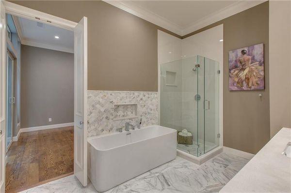 Marble tub surround with porcelain floors in this master bath.