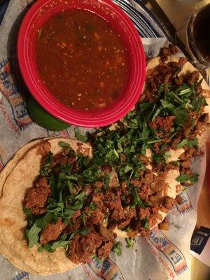 Soft tacos with steak, sausage, cilantro and lime.