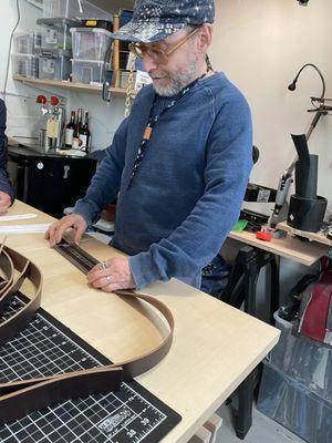 Larry in his workroom, explaining how to measure for belt making.