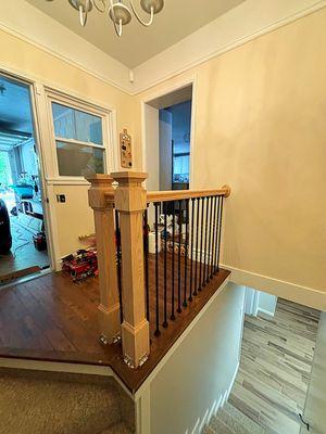 Oak Newel posts, oak hand rails and iron balusters.