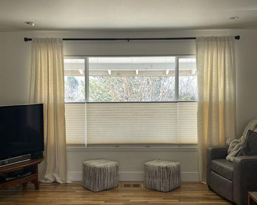 Top down bottom up light filtering cellular shades paired with linen side panels.