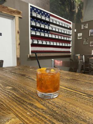 Double Old Fashioned with their memorial wall in the background