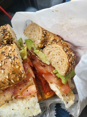 Bacon tomato avocado & egg bagel on an everything whole wheat