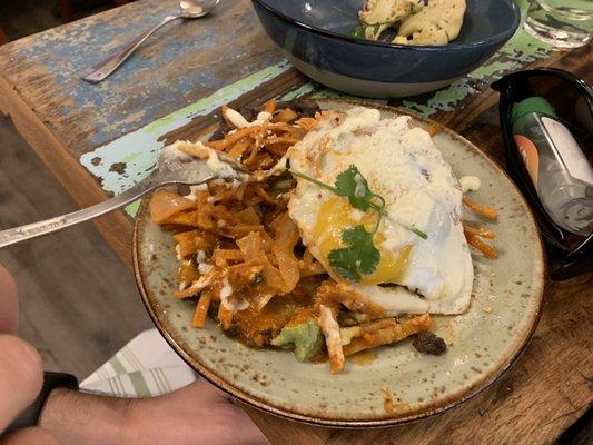 Chilaquiles - huge size. This was after we took a bite. Delicious and great for splitting