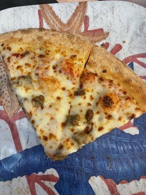 A very poorly cut and uneven topped large pizza.