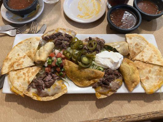 Botanas platter. Has quesadillas, fajita beef nachos, little fried empanada things with meat ( I think pork), and the shrimp egg rolls.