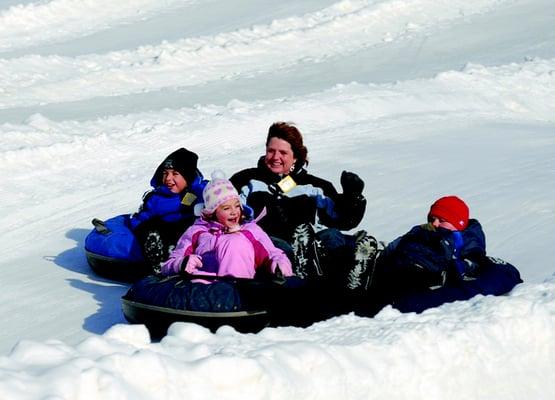 A family out enjoying Polar Blast Snow Tubing.