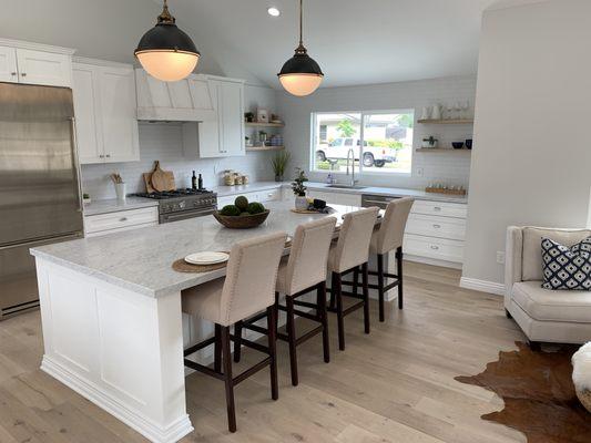 Shaker white cabinets, quartz countertops, subway style backsplash.