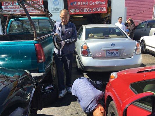 Henry is working on the tire of my car. He is fast honest and does great service!