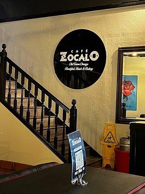 Inside stairs walking by and tables at Cafe Zocalo