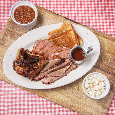 Three-meat plate with brisket, chicken and sausage, slaw and beans