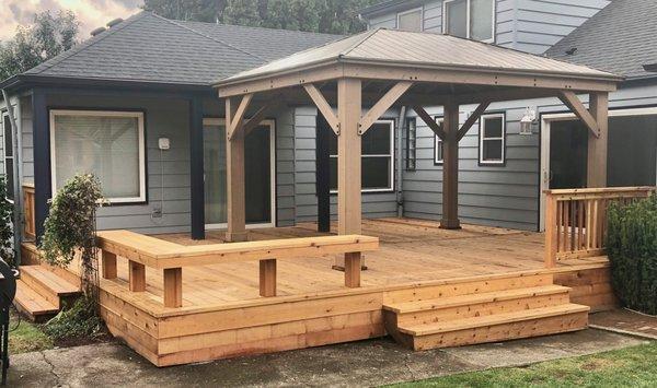 Large all cedar deck with custom bench all stained with Penofin stain.  We also built and mounted that Costco kit awning.