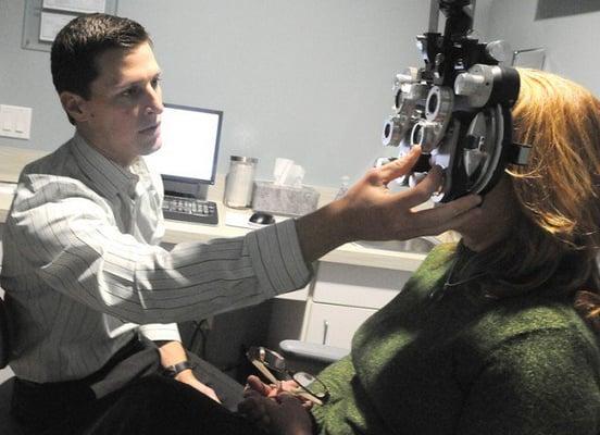 Dr. Batey using the phoropter to determine a patient's refractive error