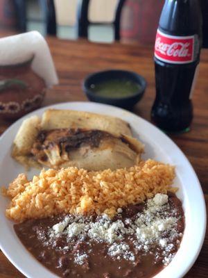 Two tamales w rice and beans.